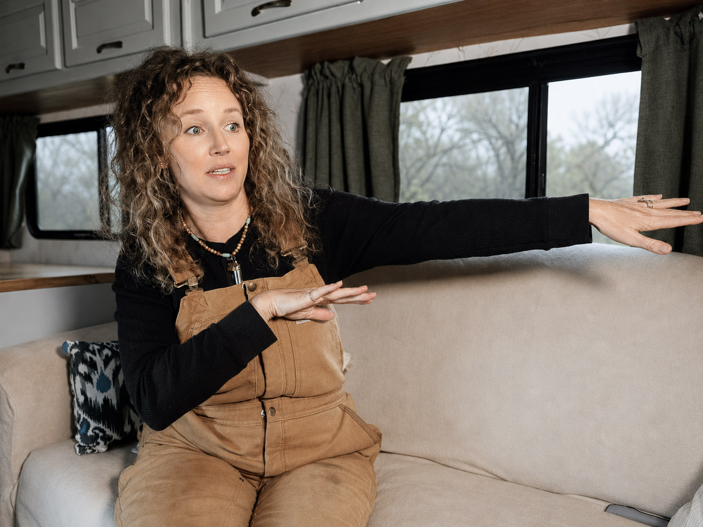 A woman telling her story from the couch of her converted RV